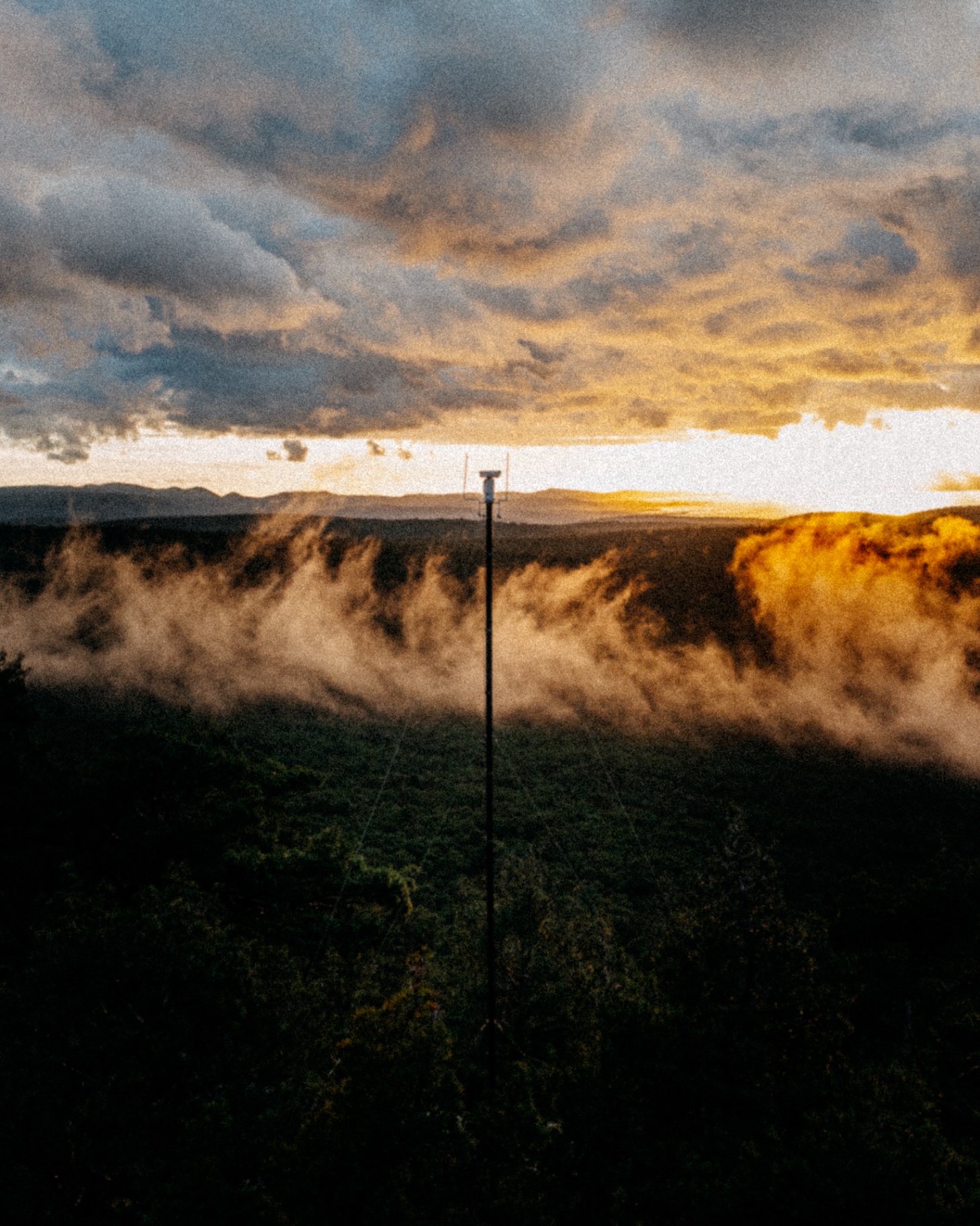 A LAST-Fire tower silhouetted against a sunset, protecting private land
